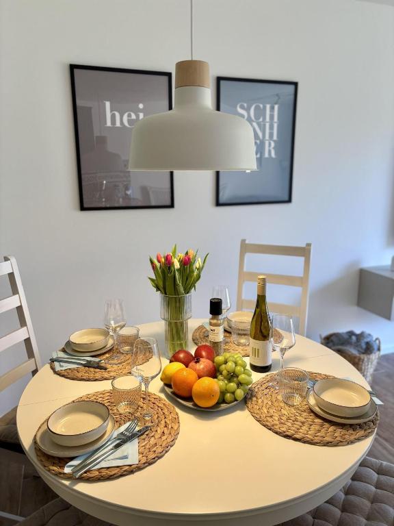 a dining room table with fruits and wine bottles at Ferienwohnung Nordig in Garding