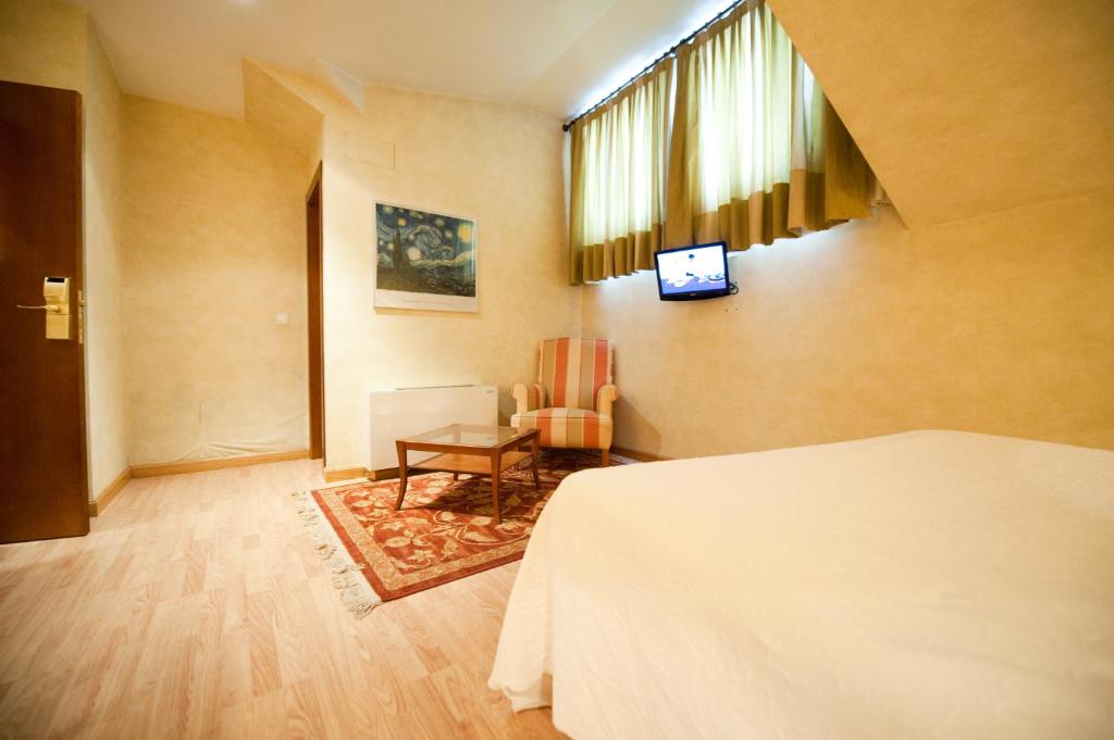 Postel nebo postele na pokoji v ubytování Hotel Cordón