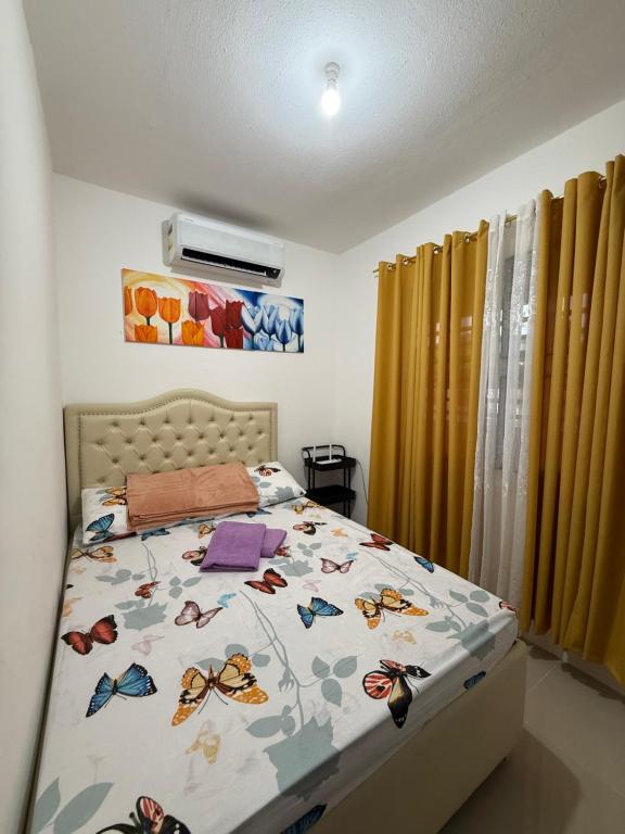 a bedroom with a bed with butterflies on it at Private Cozy Home in Tagum