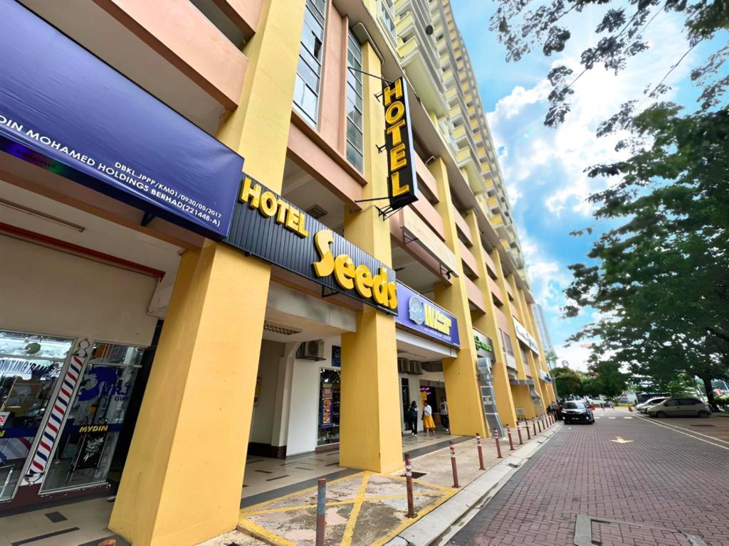 a building with a hotel sign on the side of a street at Seeds Hotel Danau Kota PV12 in Kuala Lumpur