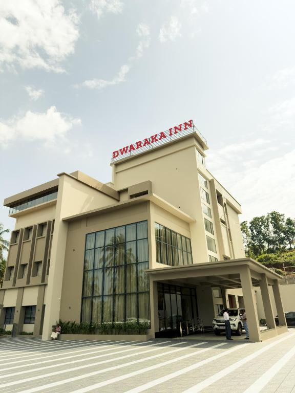 a man stands in front of a building at Dwaraka INN in Arīkkod