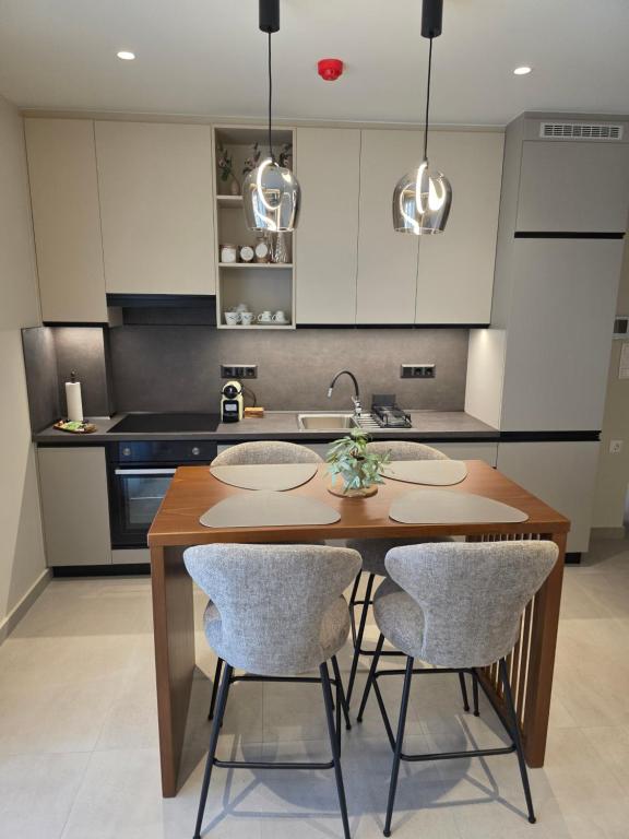 a kitchen with a wooden table and two chairs at Velithea Luxury Suites in Ioannina