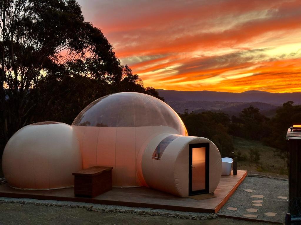 a dome house with a sunset in the background at Romantic Stargazing Retreat - Beyond Bubbles in Kanimbla