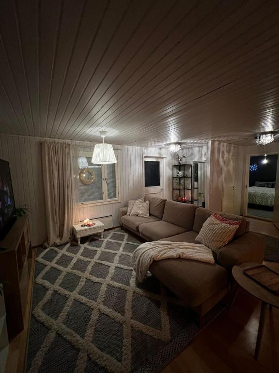 a living room with a couch and a table at Aurora Gateway N4 in Inari