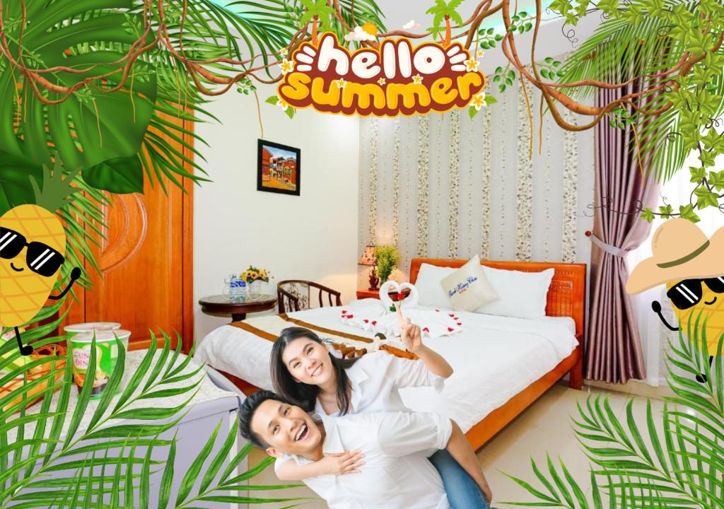 two girls sitting on a bed in a hotel room at Thành Hoàng Châu Hotel in Danang