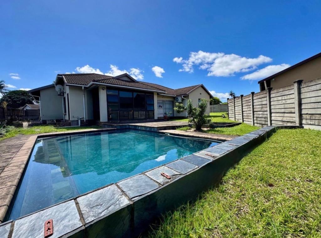 a swimming pool in the yard of a house at One Birdswood in Richards Bay