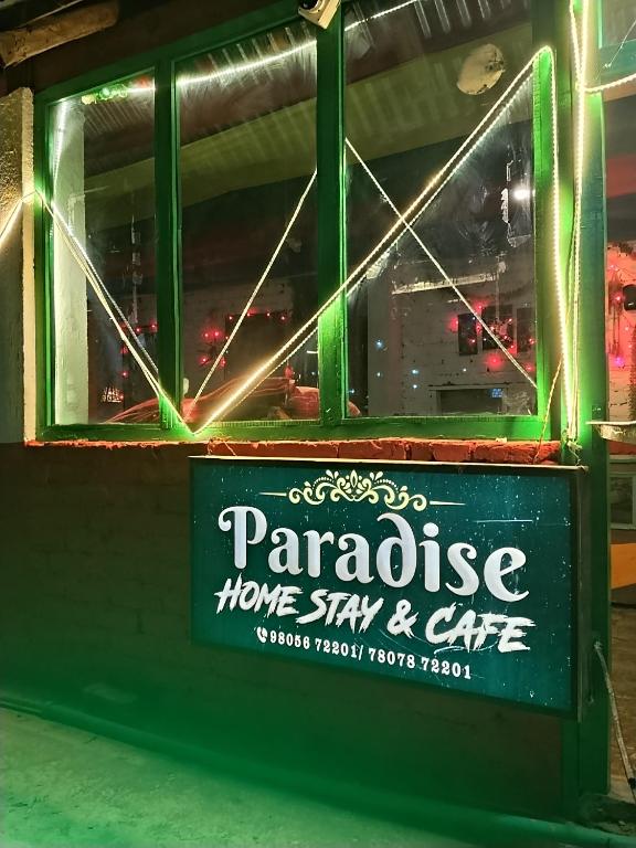 a sign for a parakeet home stay and cafe at Paradise Homestay Tosh in Tosh