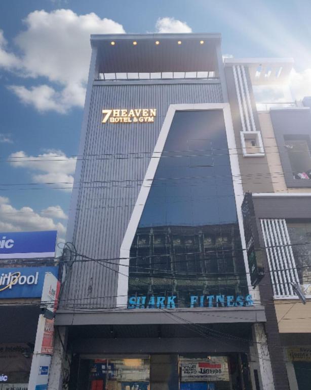 a building with a sign on the side of it at Hotel 7heaven in Kānpur