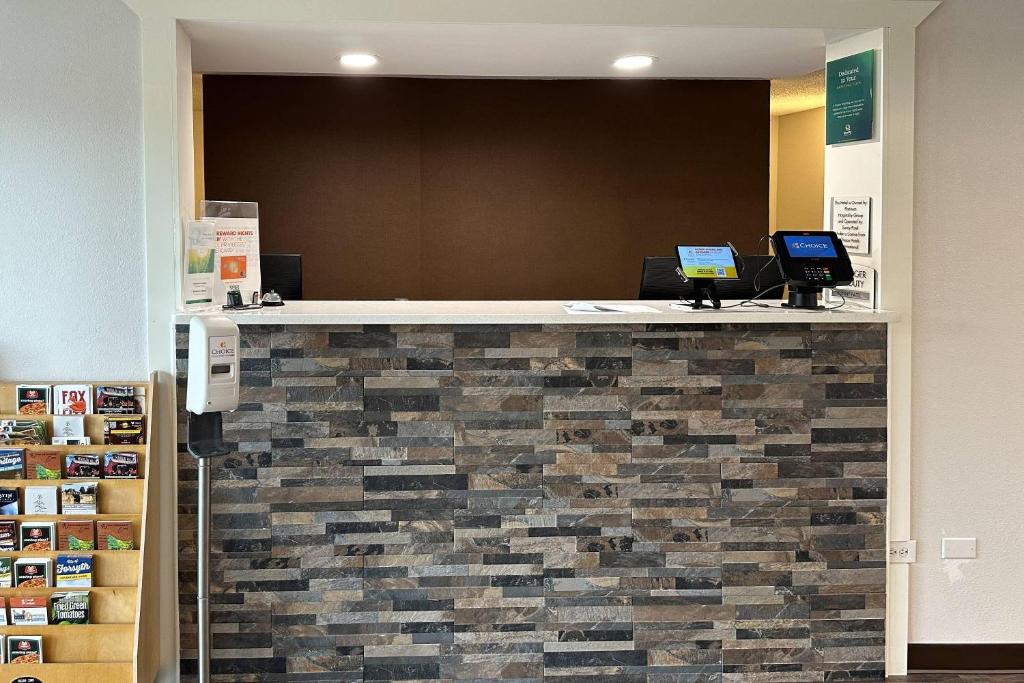 a lobby with two laptops sitting on a counter at Quality Inn Forsyth near GA Public Safety Training Center in Forsyth
