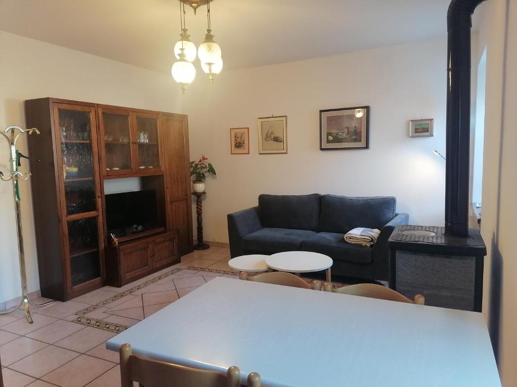 a living room with a couch and a table at Casa Fabiola in Longarone