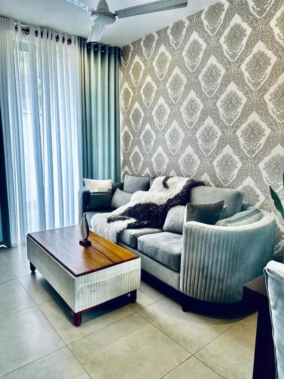 a living room with a couch and a coffee table at Sea esta villa in Mount Lavinia
