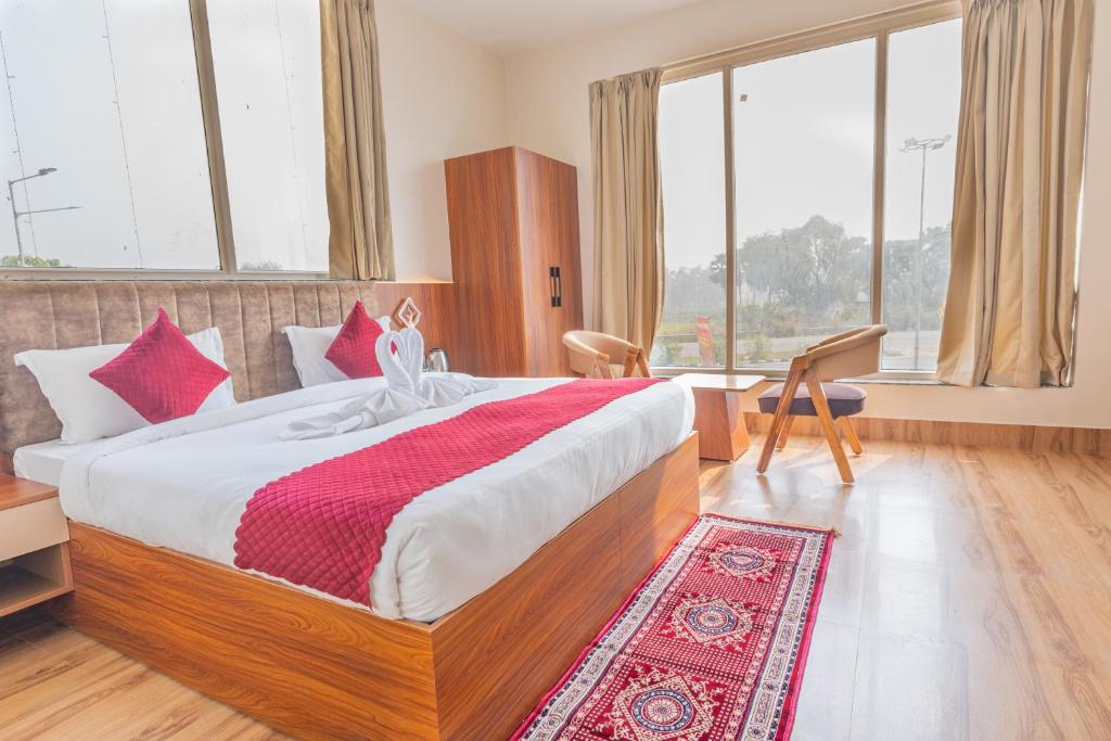 a bedroom with a large bed with a red and white blanket at Hotel Annapurna The Luxurious in Nalanda