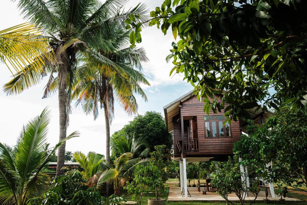a wooden house in the middle of trees at Shine Villa Sukhothai in Sukhothai