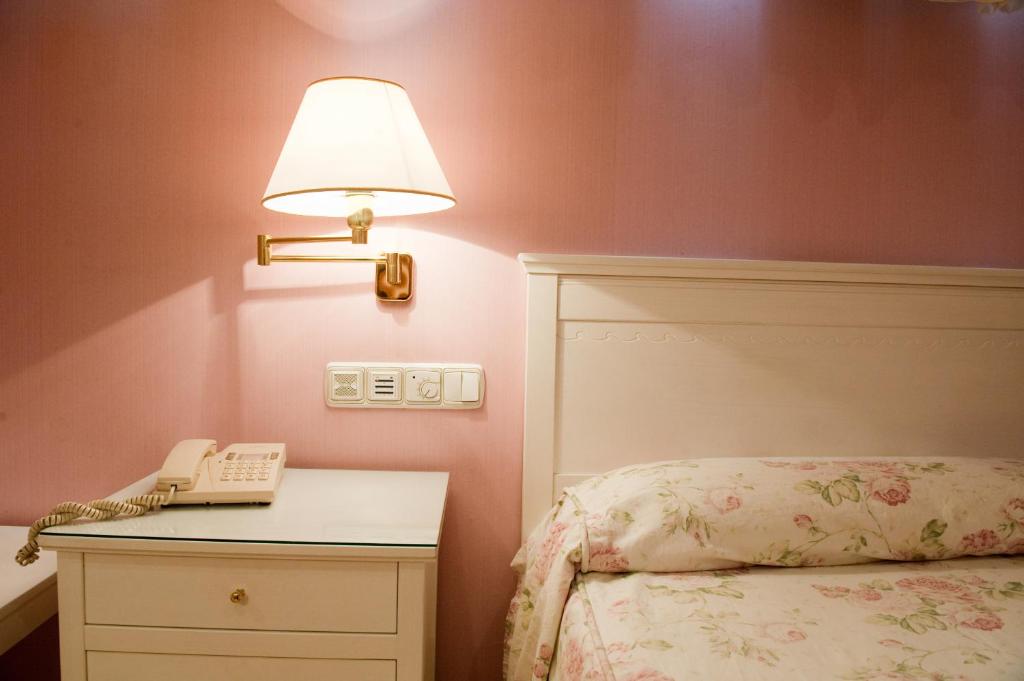 Postel nebo postele na pokoji v ubytování Hotel Cordón