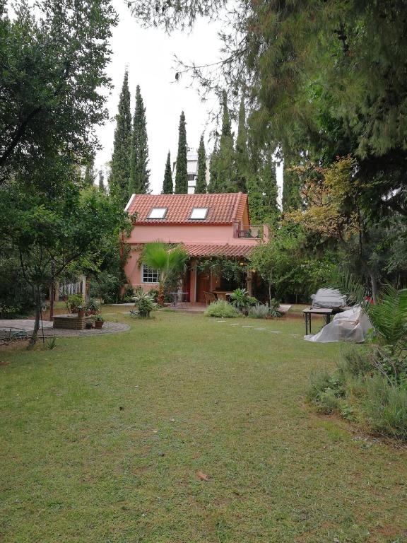 a house with a yard in front of it at Villa with big garden in Athens