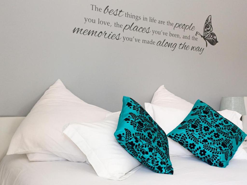 a bedroom with a bed with a butterfly wall decal at Ceelee's Place in Bloemfontein