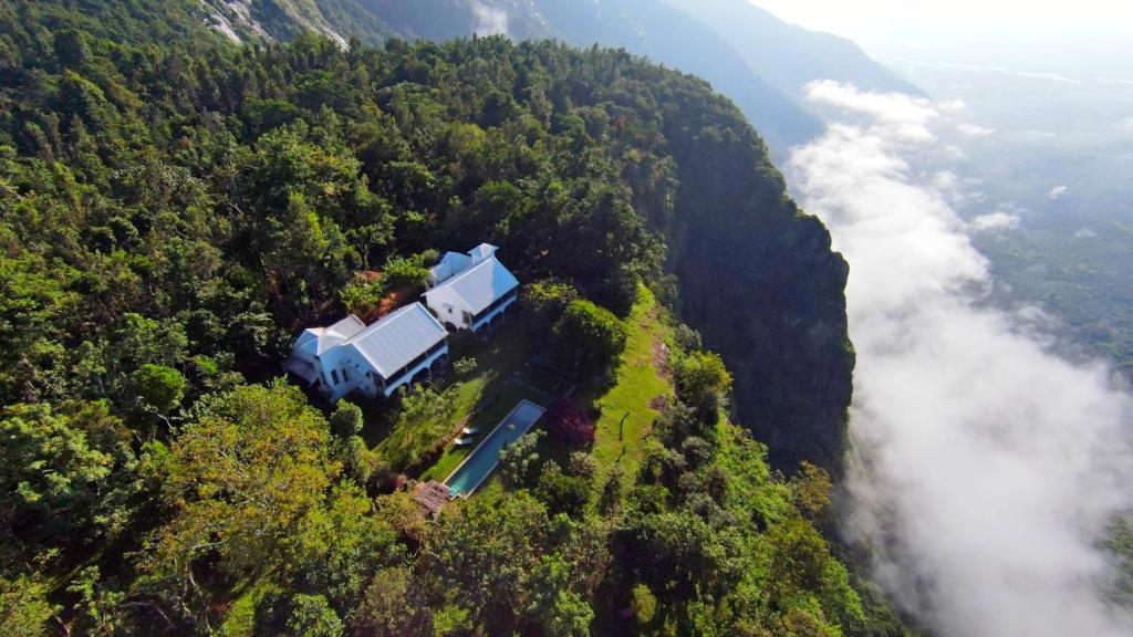 an aerial view of a house in the middle of a forest at Isla's Ridge - A CGH Earth SAHA Experience in Kodaikānāl