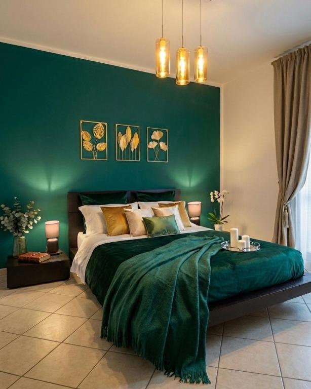 a green bedroom with a bed with a green wall at Suite 64 in Saviano