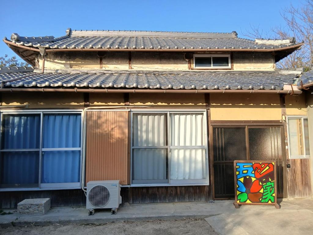 a house with a refrigerator in front of it at 五色の家 in Sumoto
