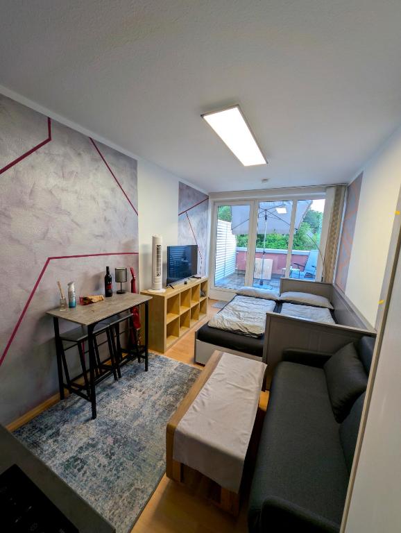 a living room with a couch and a table at Entspannen in Passau an der Donau inklusive Netflix in Passau