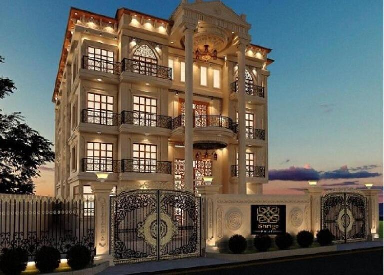 a large white building with lights on it at Sshubh Hotel Nathdwara in Nāthdwāra