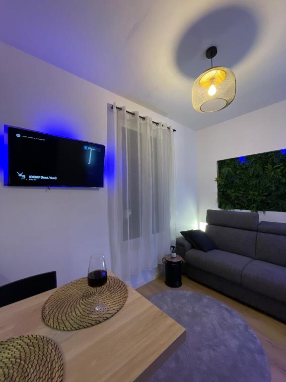 a living room with a couch and a table at All in relaxation in Toulouse
