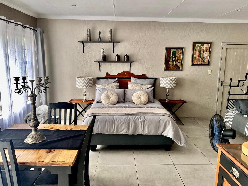 a bedroom with a bed and a table and a dining room at ColtsRest in White River