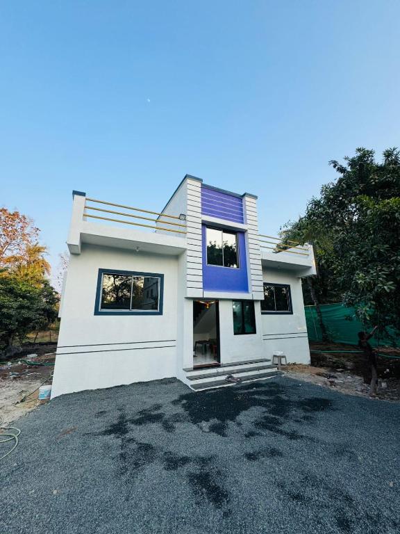 a house sitting on top of a parking lot at Ranchhod Villa in Marwad