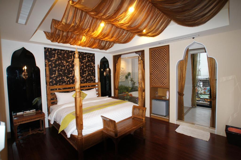a bedroom with a large bed with a canopy at Xiu Feng in Kenting