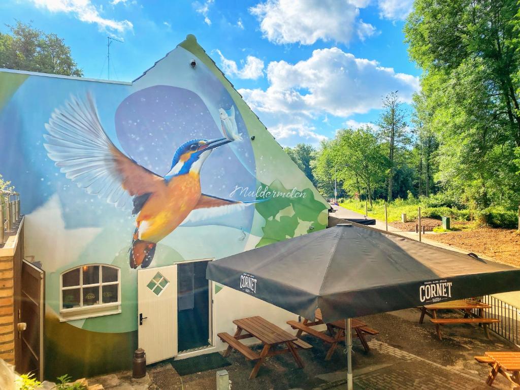 a building with a painting of a bird on it at B&B de Muldermolen in Schinnen