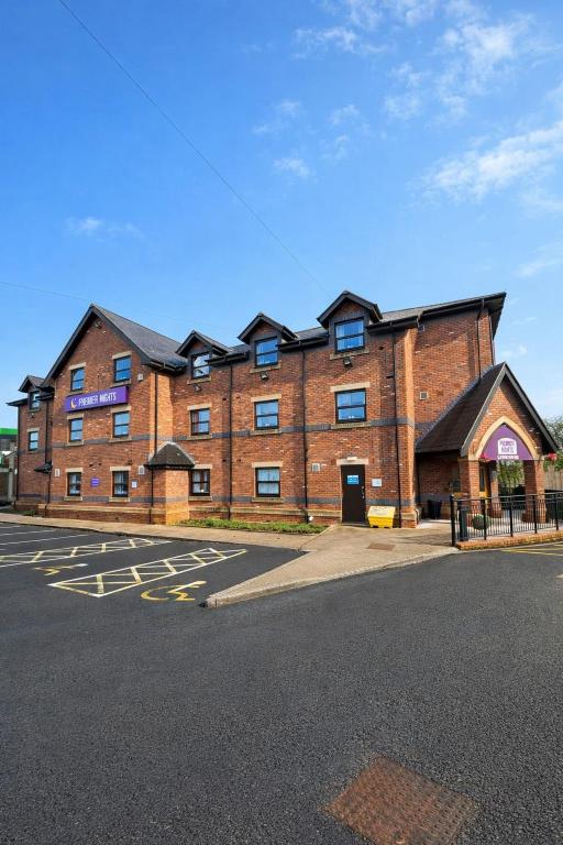 a large brick building on the side of a street at Premier Nights, Wigan, Standish M6 J27 in Standish