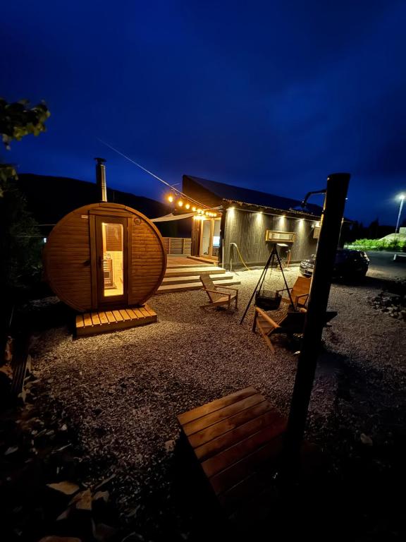 a circular house with a lit up backyard at night at The Container House in Fyresdal