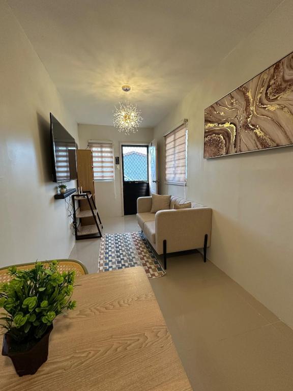 a living room with a couch and a table at Ormoc Gdex Transient in Ormoc