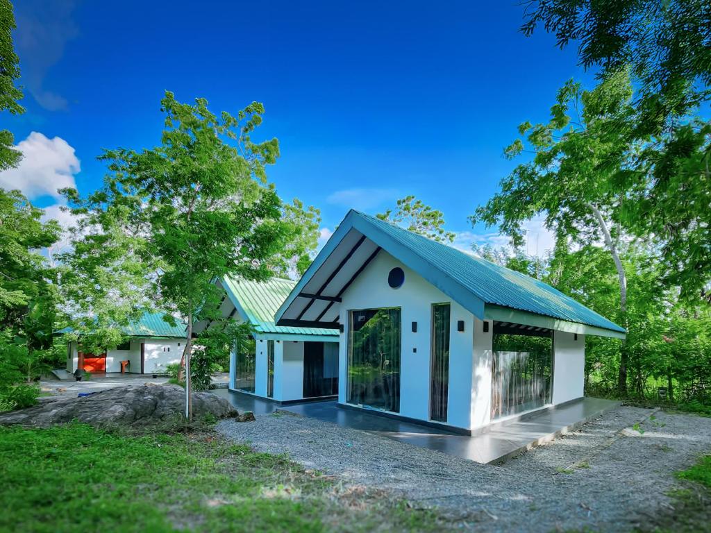 a small house with a blue roof at Euro Elephant Yala in Tissamaharama
