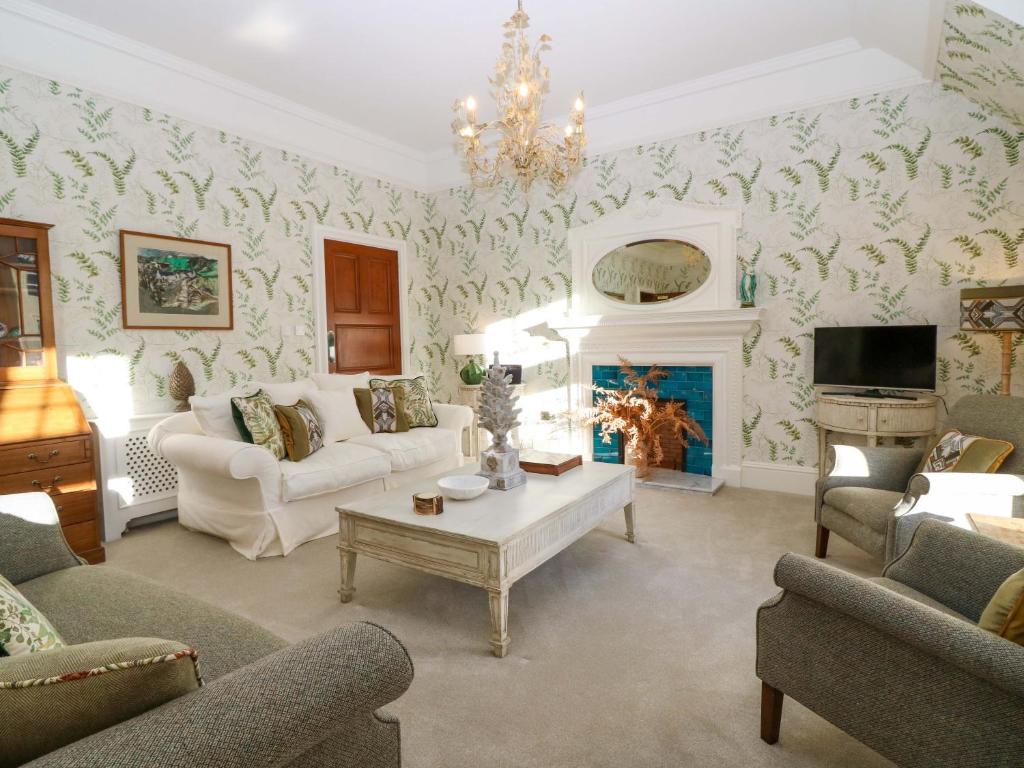 a living room filled with furniture and a fireplace at Braeriach - Mar Lodge Estate in Ballater
