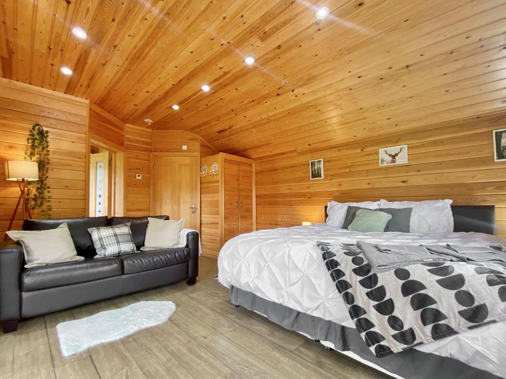 a bedroom with a bed and a couch at Maple - Uk46284 in Camerton