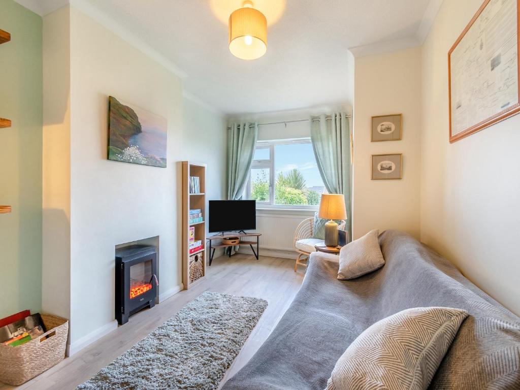 a living room with a couch and a fireplace at Arosfa in St. Davids