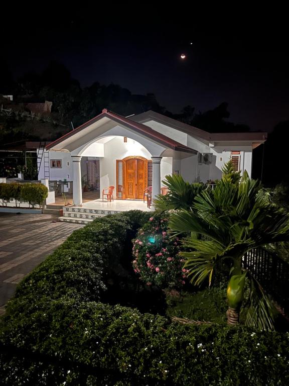 a small white house at night at Nethra Darshan in Mangalore