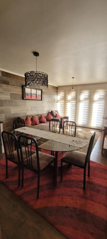 a living room with a table and a couch at Depto 3 in Villarrica
