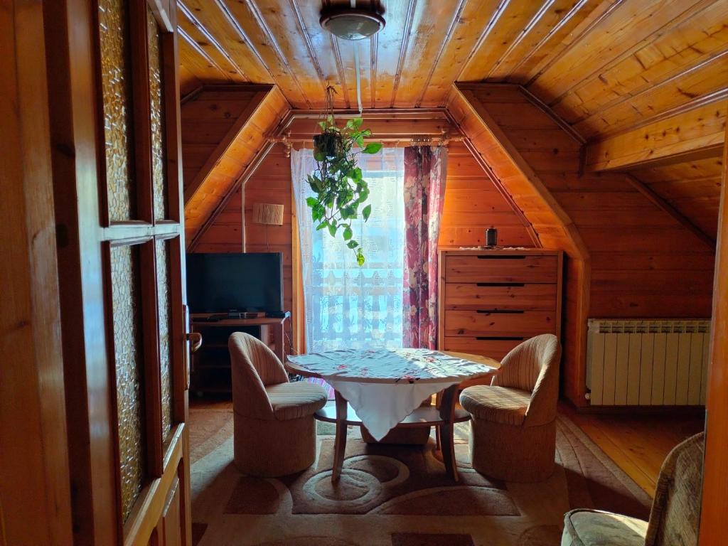 a kitchen with a table and chairs in a room at Agroturystyka u Anieli - Wśród Gór i Ziół in Krośnica
