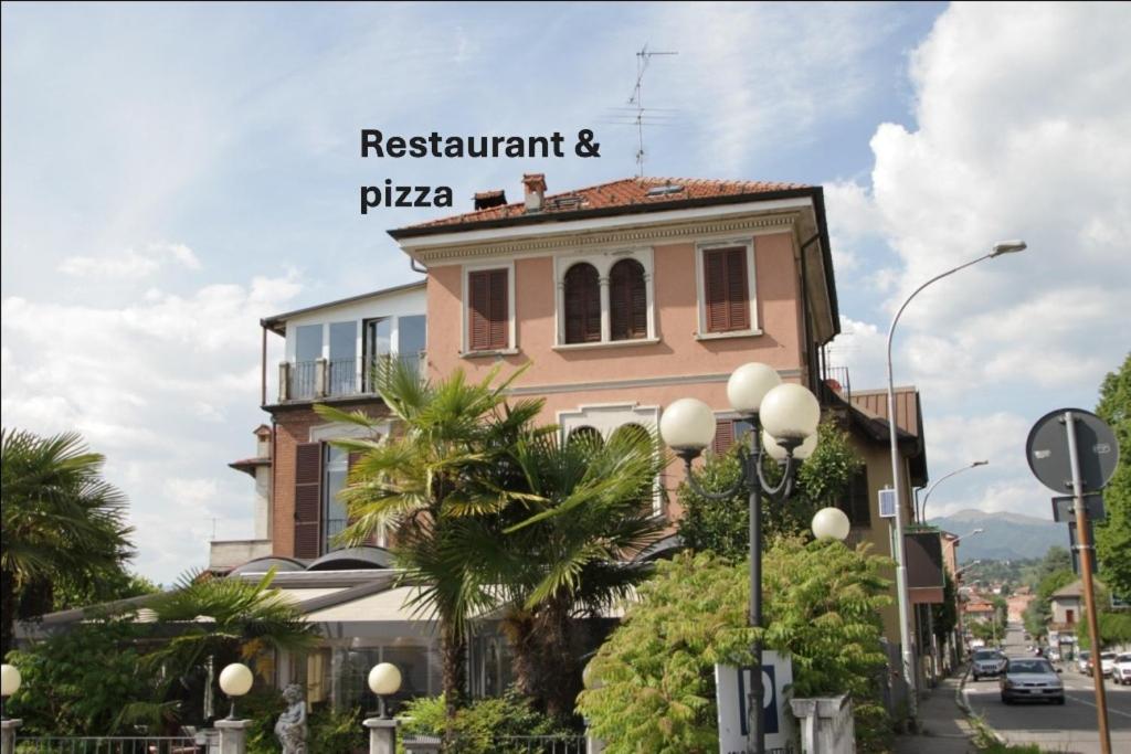 a building with a sign on top of it at Villa Oldrado in Cantù