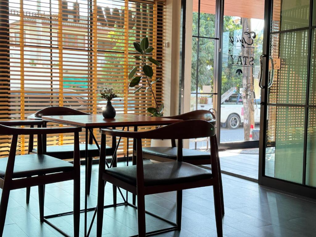 A bright dining area beside the hotel entrance and street-facing windows.