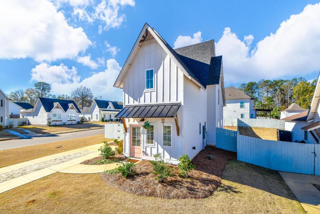 a white house with a blue fence at Nova's Nook in Auburn in Auburn