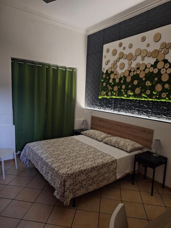a bedroom with a bed and a green curtain at Fontanarossa Airport Home in Catania
