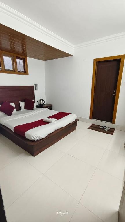 a bedroom with a large bed in a room at Hotel Millilium Inn in Gangtok