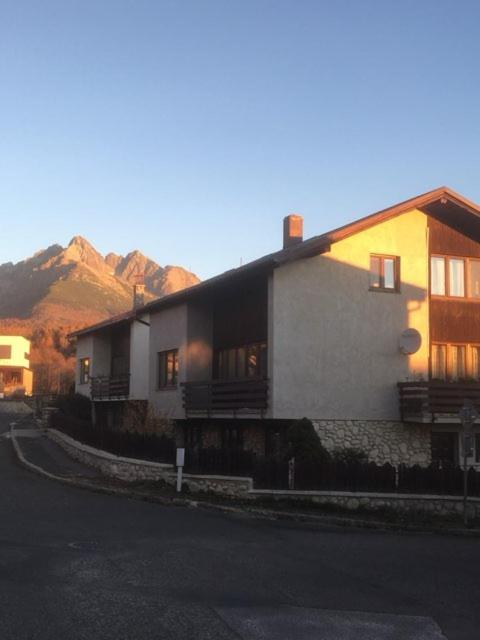 a house on the side of a street with a mountain at Privat u Frey in Nová Lesná