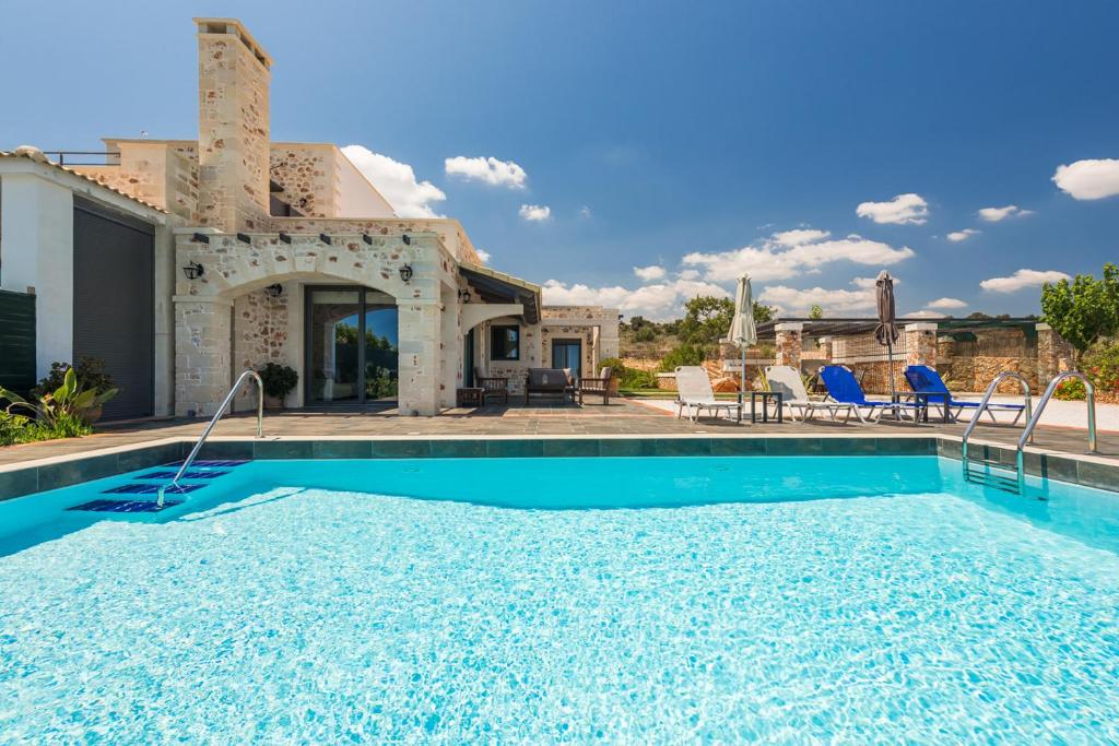 a villa with a swimming pool and a house at Villa Resi in Vamos