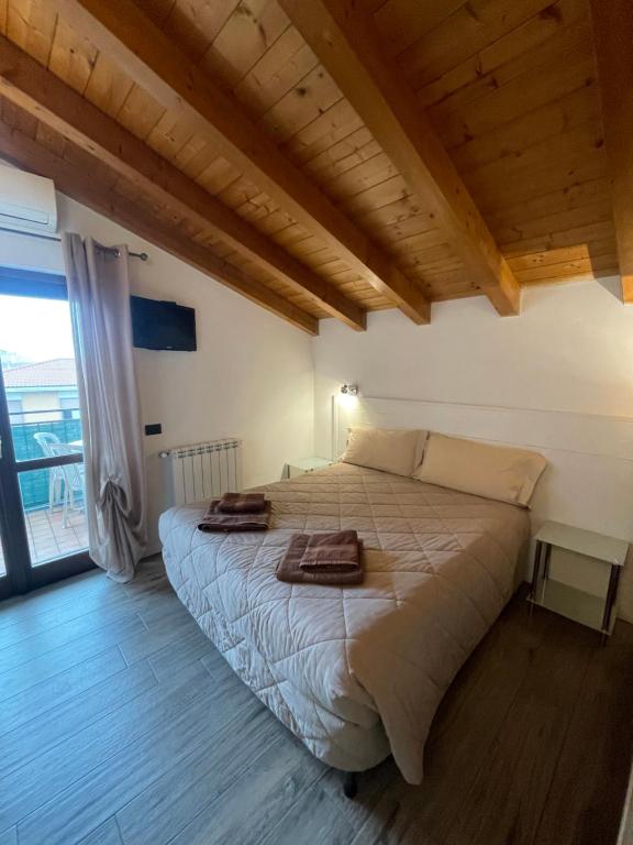 a bedroom with a bed with towels on it at Homely - Malpensa & Fiere Milano in Cardano al Campo