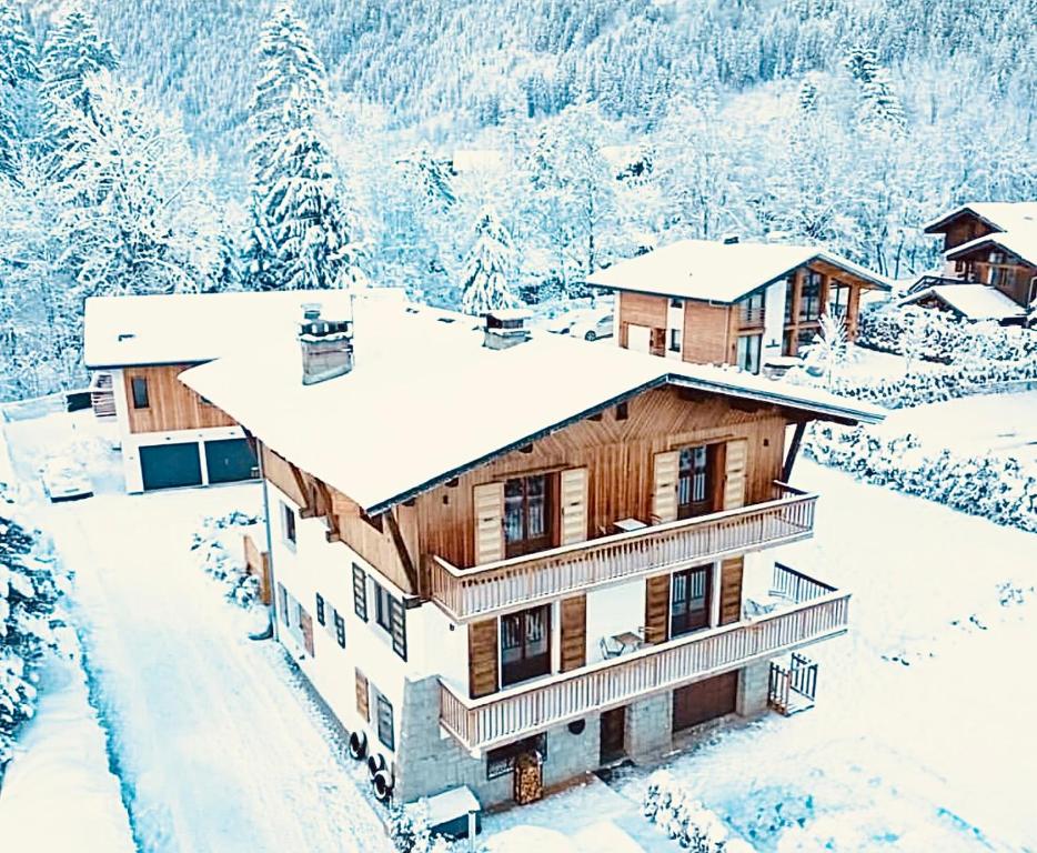 a house covered in snow in the mountains at Sauna Bain Nordique Cinéma Vue Montange in Chamonix
