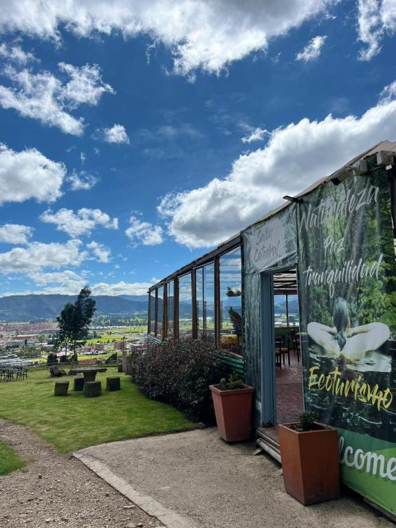 a building with a sign on the side of it at GLAMPING RESERVA CATEDRAL Zipaquira in Zipaquirá